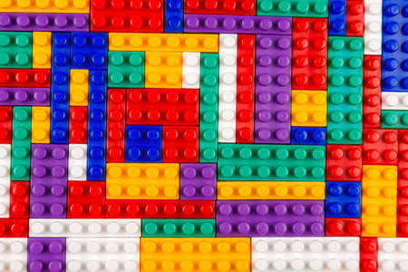 Abstract background texture of colored constructor blocks. Background of colorful plastic part of constructor. Pile of colored toy bricks.の写真素材