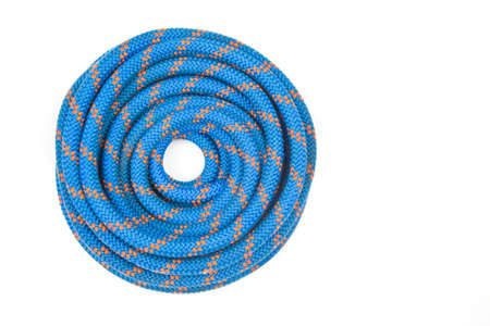 durable colored rope for climbing equipment on a white background. coil of braided cable. item for...