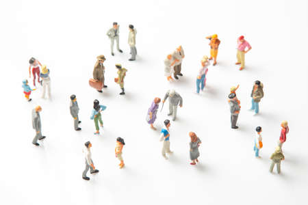 miniature people. different people stand on a white background. communication of society of different generationsの写真素材