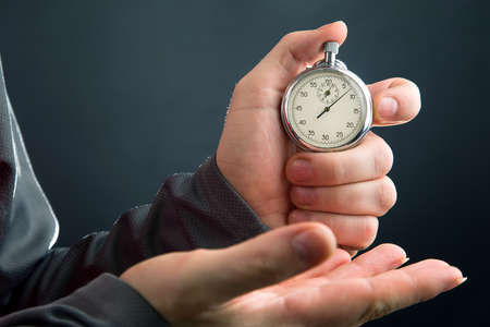 mechanical stopwatch in hand. Time part precision. Measuring the speed interval with a watchの写真素材