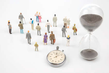 miniature people. mechanical stopwatch on the background of business people. Part time accuracy for...