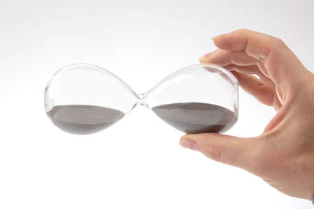 Hourglass on a light background. Time is money. business solutions in time.