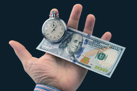 mechanical stopwatch and dollars in man hand. Part time accuracy for business. business and finance time.の写真素材