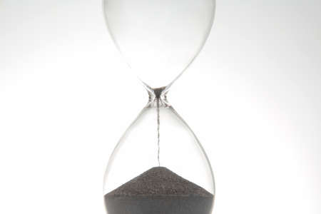 Hourglass on a light background. Time is money. business solutions in time.