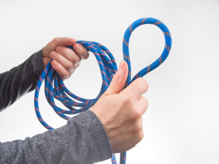 hand holds colored rope for climbing equipment. item for camping and climbingの写真素材