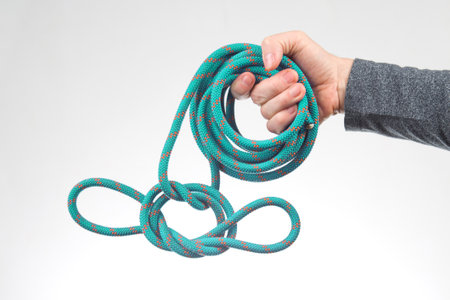 hand holds colored rope for climbing equipment. item for camping and climbing