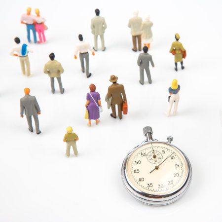 miniature people. mechanical stopwatch on the background of business people. Part time accuracy for business. business and finance timeの写真素材