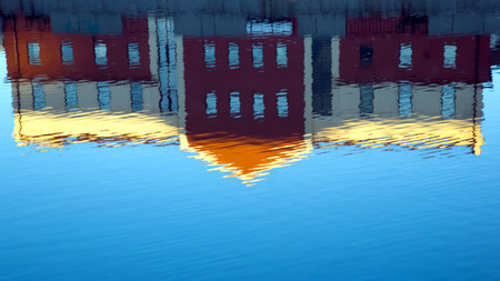 reflection of the house in the water against the skyの写真素材