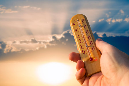 Thermometer for measuring temperature in nature against the background of the sky in the summer hot weatherの写真素材
