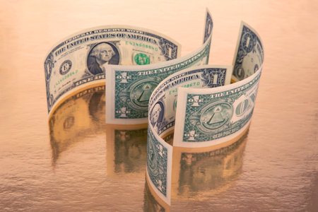 labyrinth of dollars on a golden background. financial wall of success. business conceptの写真素材