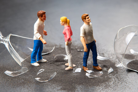 miniature people. people near the broken hourglass. crisis of personal relationships. concept of communication and disputeの写真素材