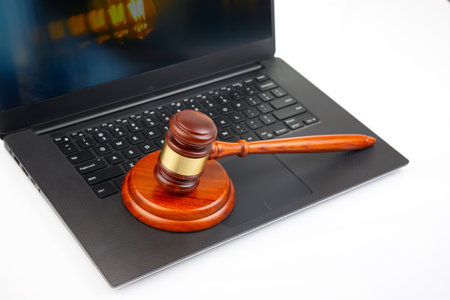 court and auction gavel on laptop background. online law and consultation.の写真素材