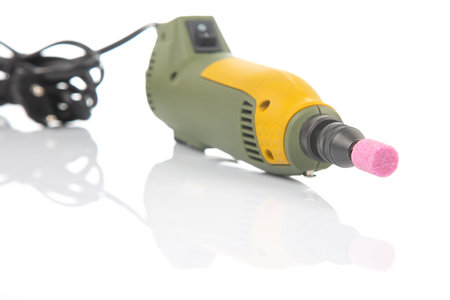 graver and drilling electric tool on a white background. dremel for processing materials and repairing partsの写真素材