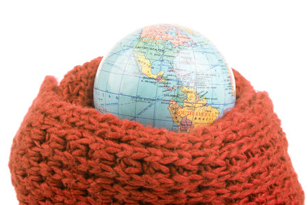 earth world globe in a warm scarf on a white background. global warming of the atmosphere. world weatherの写真素材