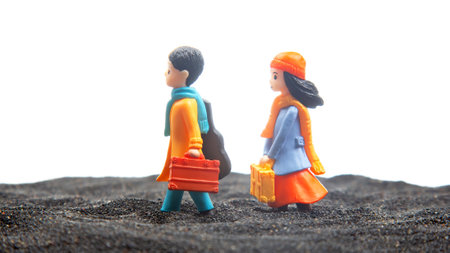 miniature people. figures for the game. romantic couple of young people. boy and girl walking togetherの写真素材