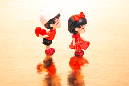 miniature people. figures for the game. romantic couple of young people. A boy lovingly gives his heart to a cute girlの写真素材