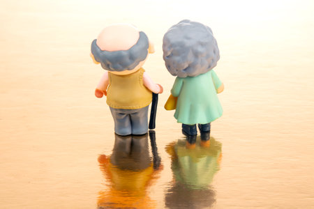 miniature people. figures for the concept. a couple of pensioners walk together. attitude and friendship in old ageの写真素材