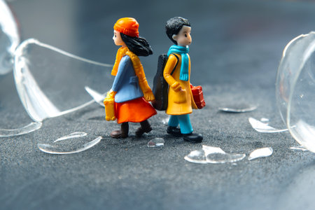 miniature people. a couple of people near a broken hourglass. crisis of personal relationships....