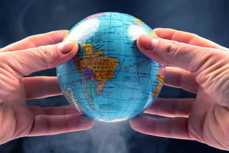 Earth world globe in hands on a dark background