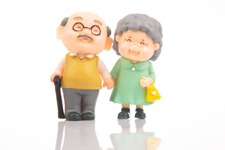 miniature people. figures for the concept. a couple of pensioners walk together. attitude and friendship in old ageの写真素材