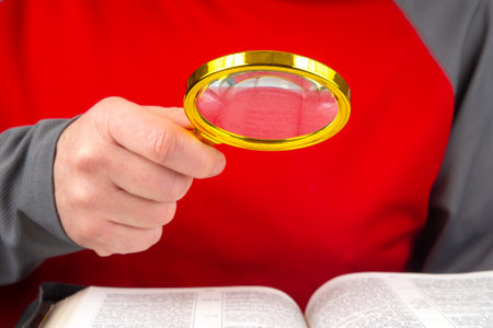 Magnifying glass for reading a book. open bible. The study of literature.の写真素材