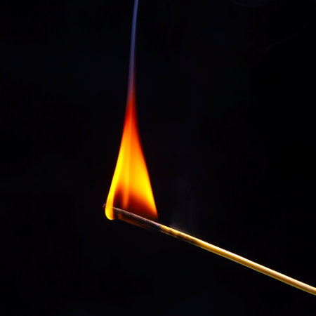 Burning wood match on a dark background close-up. burning tree fireの写真素材