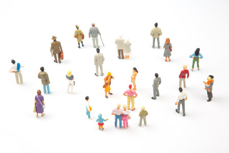 miniature people. different people stand on a white background. people communicate with each other. communication of society of different generationsの写真素材