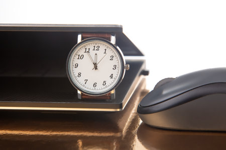 Clock and laptop with mouse. Time control for work and games online. Duration of work with a laptopの写真素材