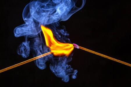 fire and smoke. Burning and smoking match on a black background. heat and light from fire flameの写真素材