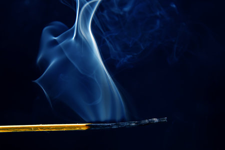 smoking match on a black background. heat and light from fire flameの写真素材