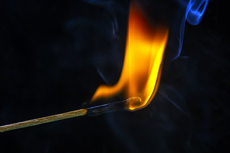 fire and smoke. Burning and smoking match on a black background. heat and light from fire flameの写真素材