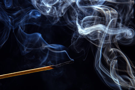 smoking match on a black background. heat and light from fire flameの写真素材