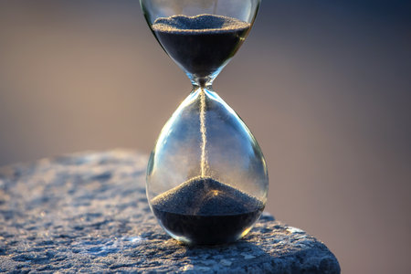 Hourglass counts the length of time against. The concept of the fluidity of life time in the universe. time and lightの写真素材
