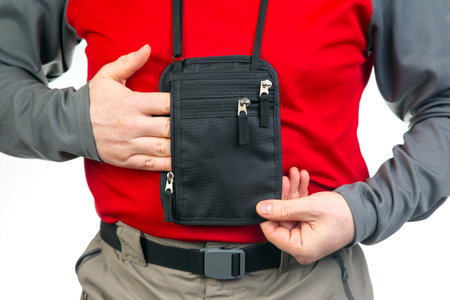 Male tourist with a waist bag for things and documents on a trip. belt bag with a zipper for things...