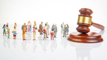 Miniature people. Many people near the gavel of law and justice. Laws to ensure the life of the society of the countryの写真素材