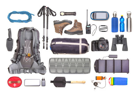 Set of tourist trekking items on white background. Top view of accessories for travel. Equipment for travel and hiking. Survival Items.の写真素材