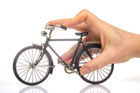 man hand on a bicycle model on a white background. cycling conceptの写真素材
