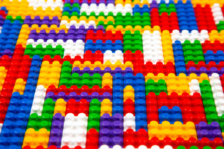 Abstract background texture of colored constructor blocks. Background of colorful plastic part of...