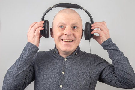 Portrait of a happy man in headphones listening to musicの写真素材