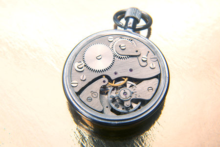mechanical analog stopwatch on a colored background. Time part precision. Measurement of the speed...