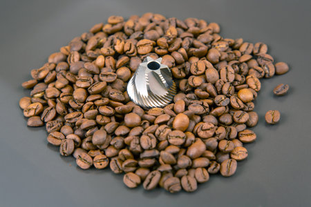 Roasted coffee beans, a burr grinder, and ground coffee, showing the coffee-making process. Ideal for beverage and kitchen themes.の写真素材