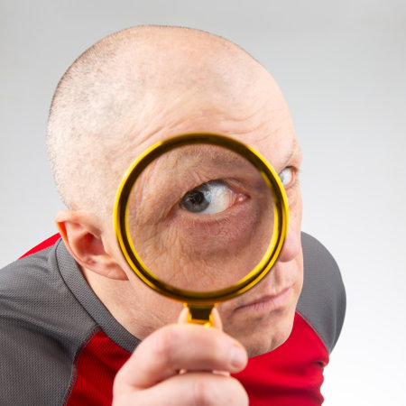 man looks through a magnifying glassの写真素材