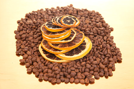 dried orange slices resting on roasted coffee beans, perfect for coffee lovers and culinary inspiration. coffee aroma and taste descriptorsの写真素材