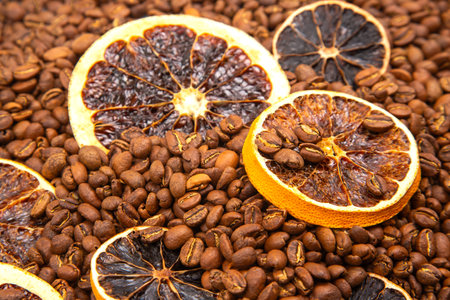 A sensory delight featuring dried orange segments layered over rich coffee beans. coffee aroma and taste descriptorsの写真素材