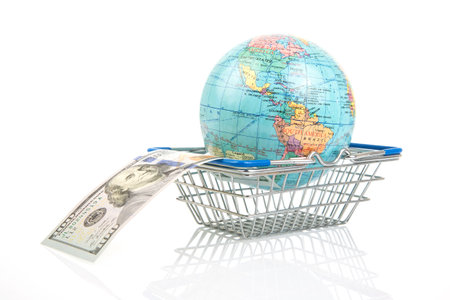 earth world globe in a grocery basket with dollars on a white background. the concept of the sale of land resources. worldwide sales businessの写真素材