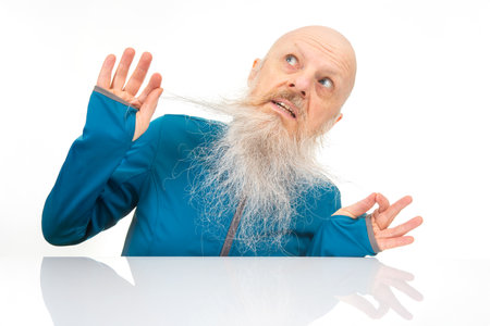portrait of a man with a large gray beard on a light background.の写真素材