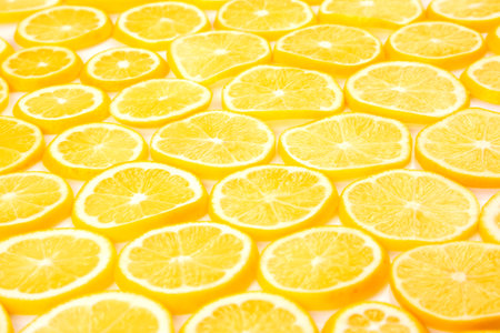 sliced citrus lemons half on a light backgroundの写真素材