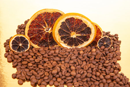 An enticing macro shot of dried citrus slices paired with dark coffee beans, highlighting their contrasting textures and earthy tones. coffee aroma and taste descriptorsの写真素材