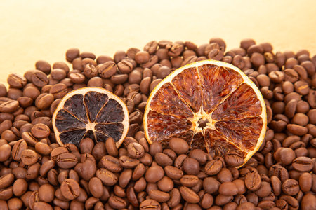 Rustic still life featuring dried orange segments scattered over a bed of rich, roasted coffee beans. coffee aroma and taste descriptorsの写真素材