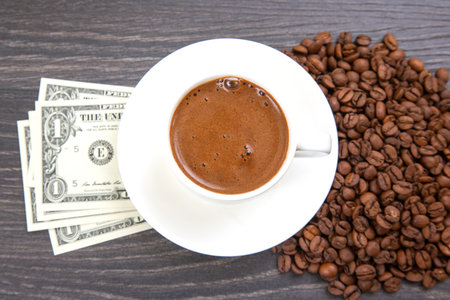 Enjoying a rich cup of coffee with fresh beans and a touch of cash on a wooden table. coffee...